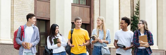 College students standing outside of a school building