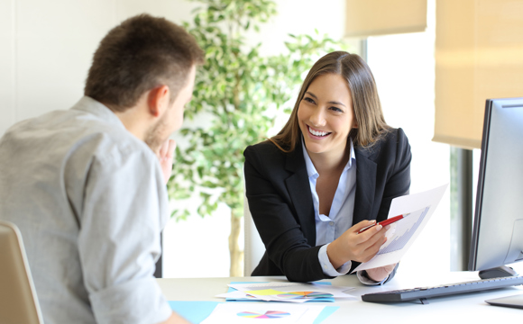 A man talking to a businesswomen.
