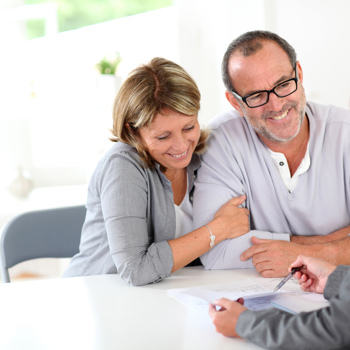 A couple happy to be meeting with a retirement planner.