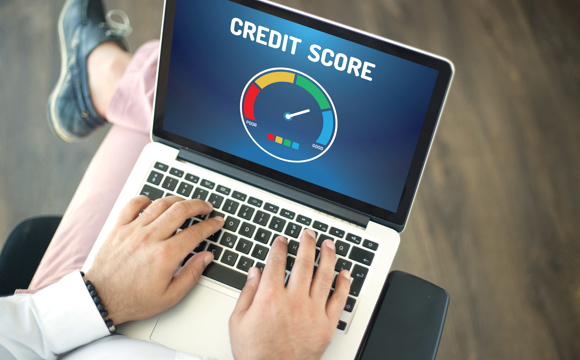 A laptop open to a credit score screen.