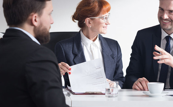 Professionals closely interacting over some design documents.