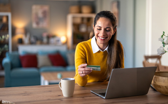 A woman with a credit card pondering finances
